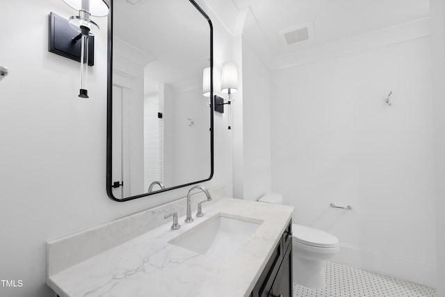 bathroom featuring visible vents, toilet, vanity, and baseboards