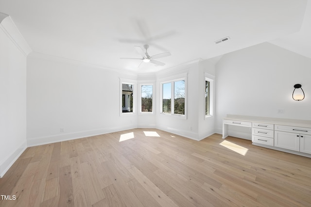 interior space featuring baseboards, visible vents, light wood finished floors, built in study area, and ornamental molding