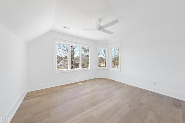 empty room featuring visible vents, a ceiling fan, light wood-type flooring, and baseboards