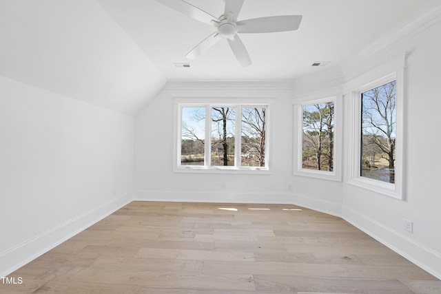 additional living space featuring a wealth of natural light, visible vents, light wood-type flooring, and baseboards