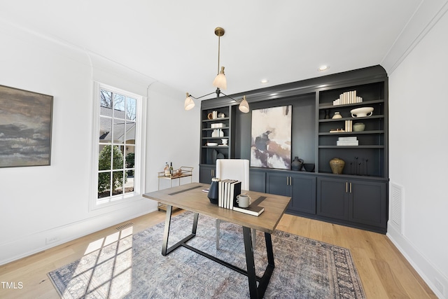 office space with ornamental molding, recessed lighting, visible vents, and light wood-type flooring