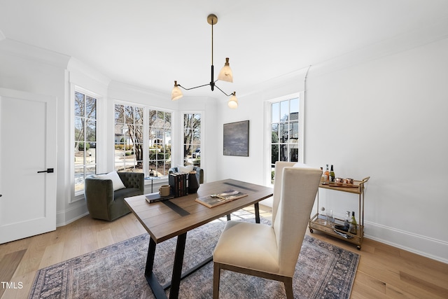 office area featuring ornamental molding, baseboards, and wood finished floors