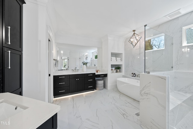 full bathroom featuring two vanities, a sink, ornamental molding, a freestanding bath, and marble finish floor