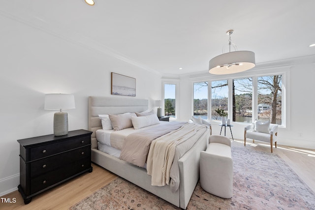 bedroom with recessed lighting, baseboards, crown molding, and light wood-style floors