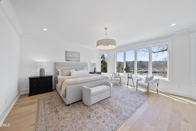 bedroom with baseboards, recessed lighting, light wood-type flooring, and ornamental molding