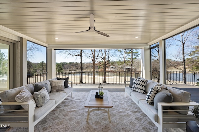 sunroom featuring plenty of natural light, wood ceiling, and a water view