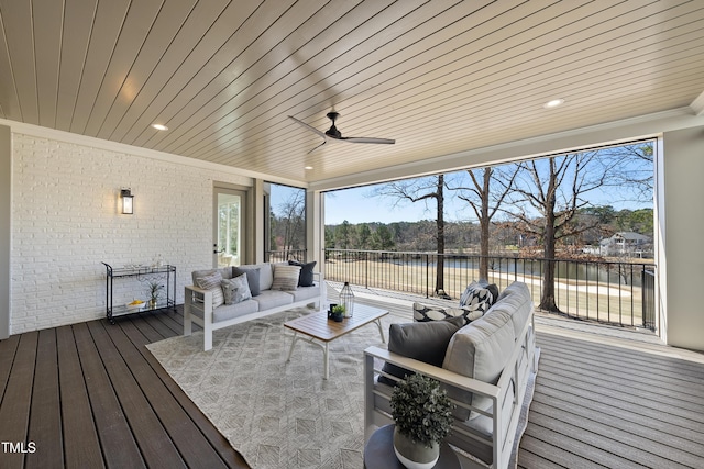 sunroom / solarium with a fireplace, wood ceiling, a ceiling fan, and a water view