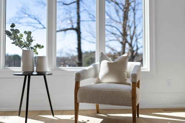 living area featuring wood finished floors and baseboards