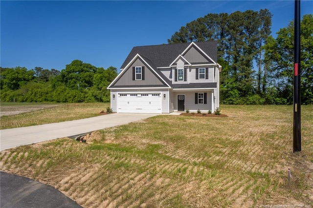 craftsman house with concrete driveway, a front yard, an attached garage, and board and batten siding