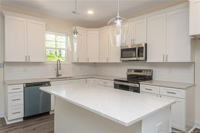 kitchen with a sink, white cabinets, appliances with stainless steel finishes, and visible vents
