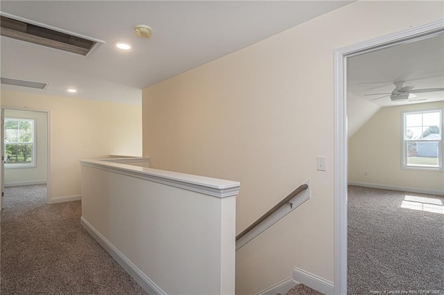 hall featuring recessed lighting, an upstairs landing, visible vents, and carpet