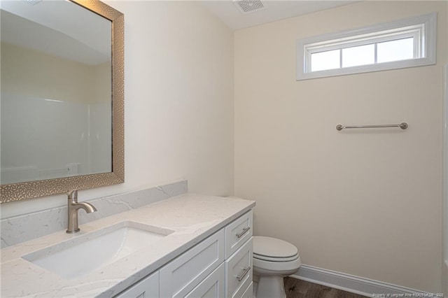 full bath with wood finished floors, walk in shower, toilet, vanity, and visible vents