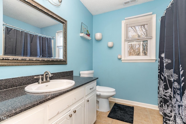 bathroom with vanity, baseboards, visible vents, tile patterned floors, and toilet