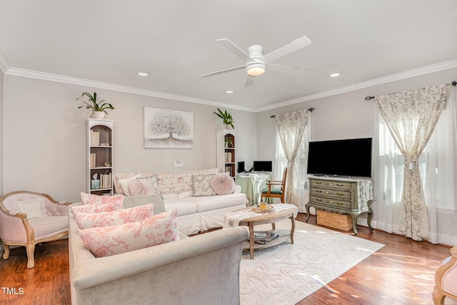 living room with crown molding, a ceiling fan, and wood finished floors