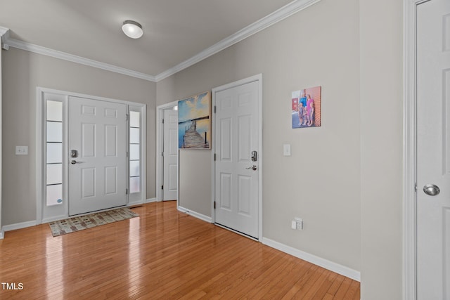 entryway featuring baseboards, light wood-style flooring, and crown molding