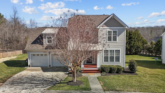 traditional-style home featuring an attached garage, concrete driveway, and a front yard