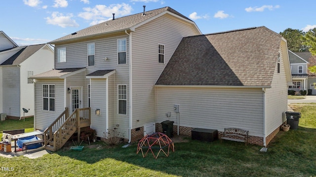 rear view of property with a yard, central AC unit, and a shingled roof