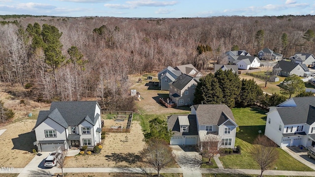 drone / aerial view with a residential view and a wooded view