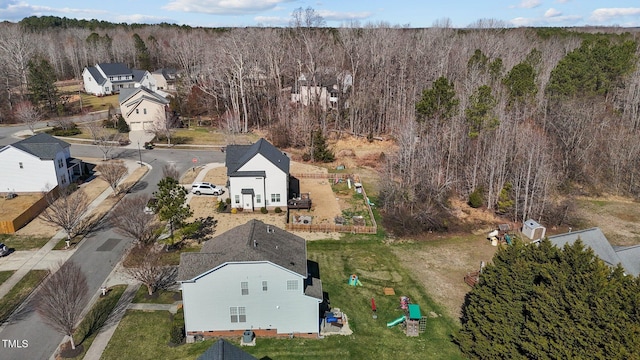 bird's eye view featuring a wooded view and a residential view