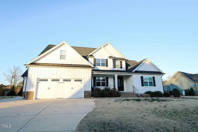 modern farmhouse style home with board and batten siding, concrete driveway, metal roof, a garage, and a standing seam roof