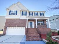 view of front of home featuring driveway, covered porch, and an attached garage