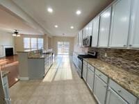 kitchen with recessed lighting, stainless steel appliances, backsplash, and open floor plan