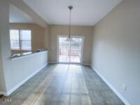 unfurnished dining area with baseboards and wood finished floors