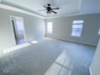 interior space featuring a tray ceiling and ceiling fan