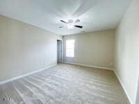 spare room featuring baseboards and ceiling fan