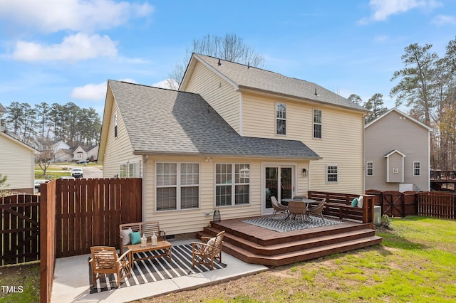 back of house featuring an outdoor living space, a yard, a fenced backyard, a shingled roof, and a deck