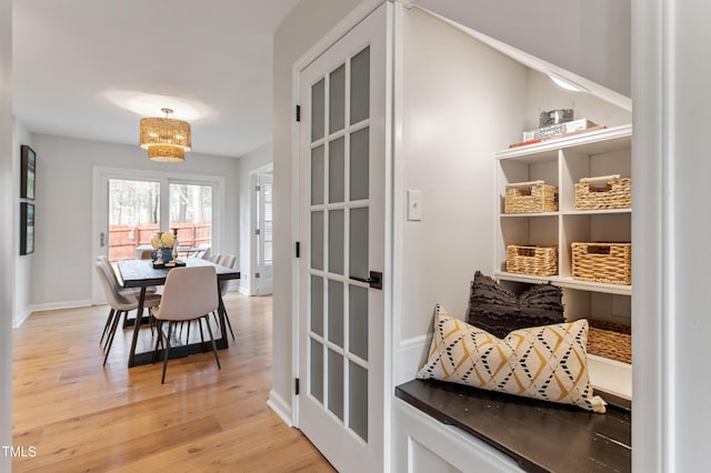 dining area with baseboards and light wood finished floors