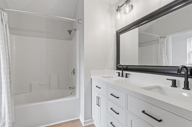 bathroom featuring a sink, shower / bathtub combination with curtain, and double vanity