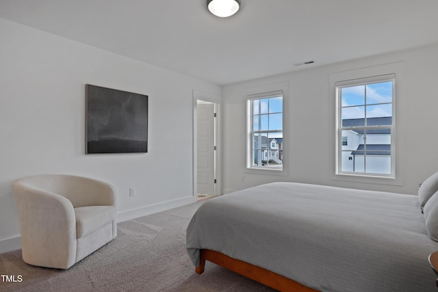 carpeted bedroom with baseboards and visible vents