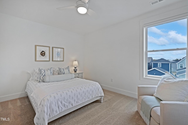 bedroom featuring baseboards, light carpet, and ceiling fan