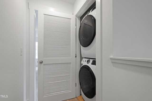 laundry room featuring laundry area and stacked washer and clothes dryer
