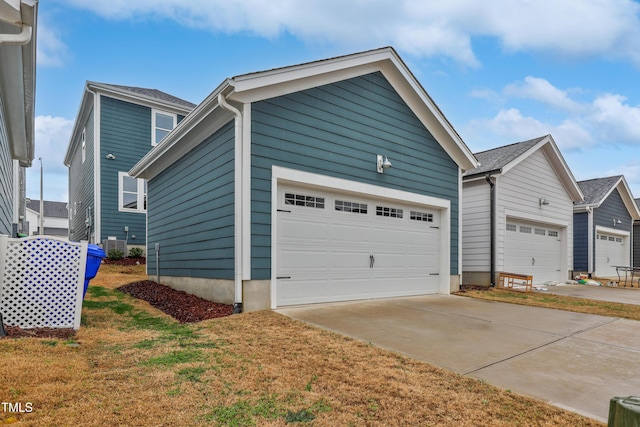 view of home's exterior with an outbuilding, a garage, and driveway