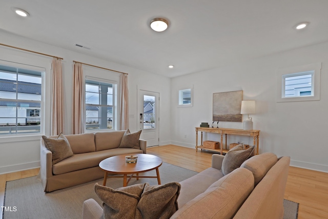 living room with visible vents, recessed lighting, wood finished floors, and baseboards