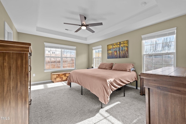 bedroom with baseboards, a raised ceiling, carpet, and ceiling fan