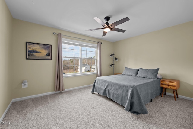 bedroom with ceiling fan, baseboards, and carpet