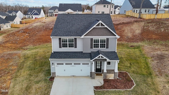 view of front of house with a garage, a residential view, driveway, and a shingled roof