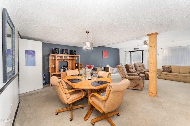 dining room featuring light colored carpet and a textured ceiling