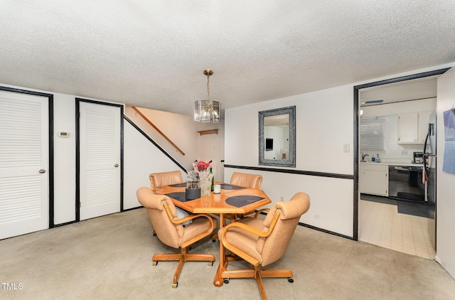 dining room with light carpet, a textured ceiling, and a chandelier