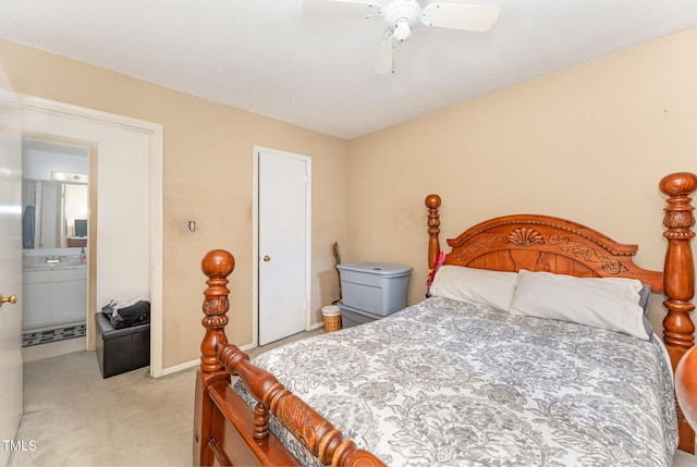 bedroom with ensuite bath, carpet flooring, and ceiling fan