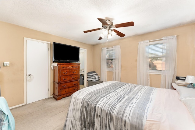 bedroom featuring light colored carpet, a textured ceiling, and ceiling fan