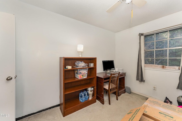 home office featuring light carpet, baseboards, and a ceiling fan