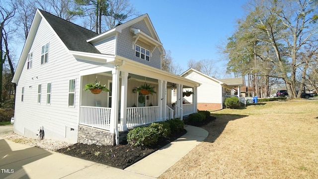 view of front of home with a porch and a front lawn