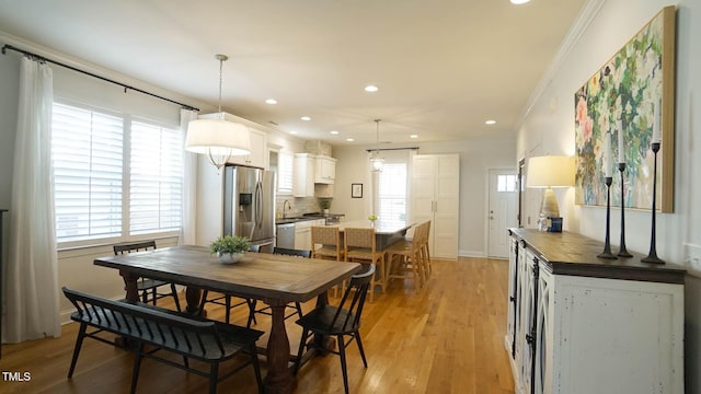 dining area with recessed lighting, baseboards, crown molding, and light wood finished floors