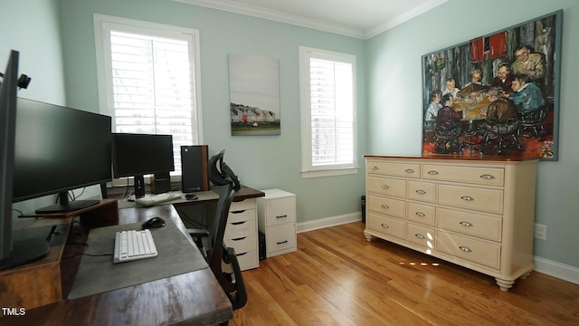 home office with light wood-style flooring, baseboards, and ornamental molding