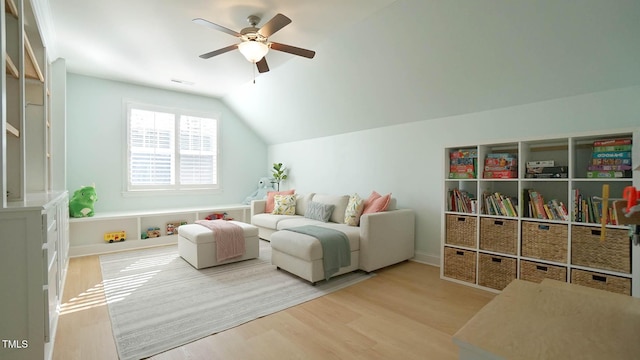 interior space with vaulted ceiling, ceiling fan, visible vents, and wood finished floors