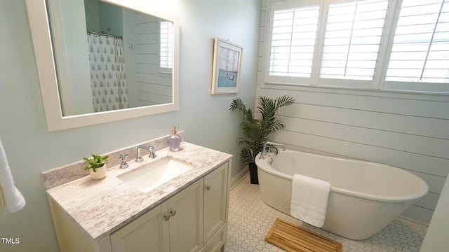 full bathroom with a soaking tub and vanity